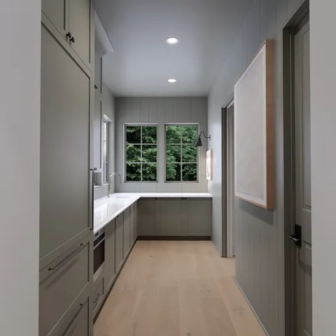 a large white kitchen with a large window