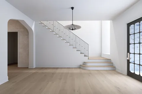 a view of entryway and hall with wooden floor