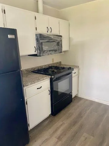 a stove top oven sitting inside of a kitchen