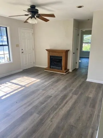 wooden floor in an empty room with a fireplace