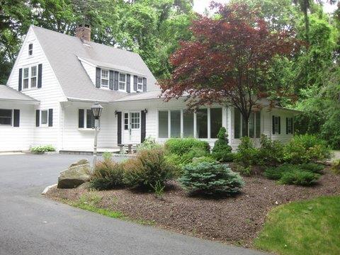 54 Weston Road Westport, CT 06880 - Photo 1 of 1 a front view of a house with a garden