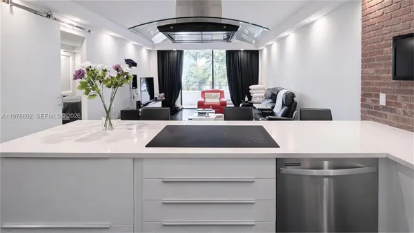 a kitchen with a stove a refrigerator and a large window