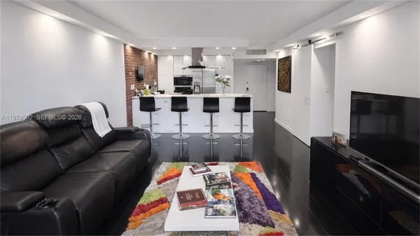 a living room with furniture and a flat screen tv