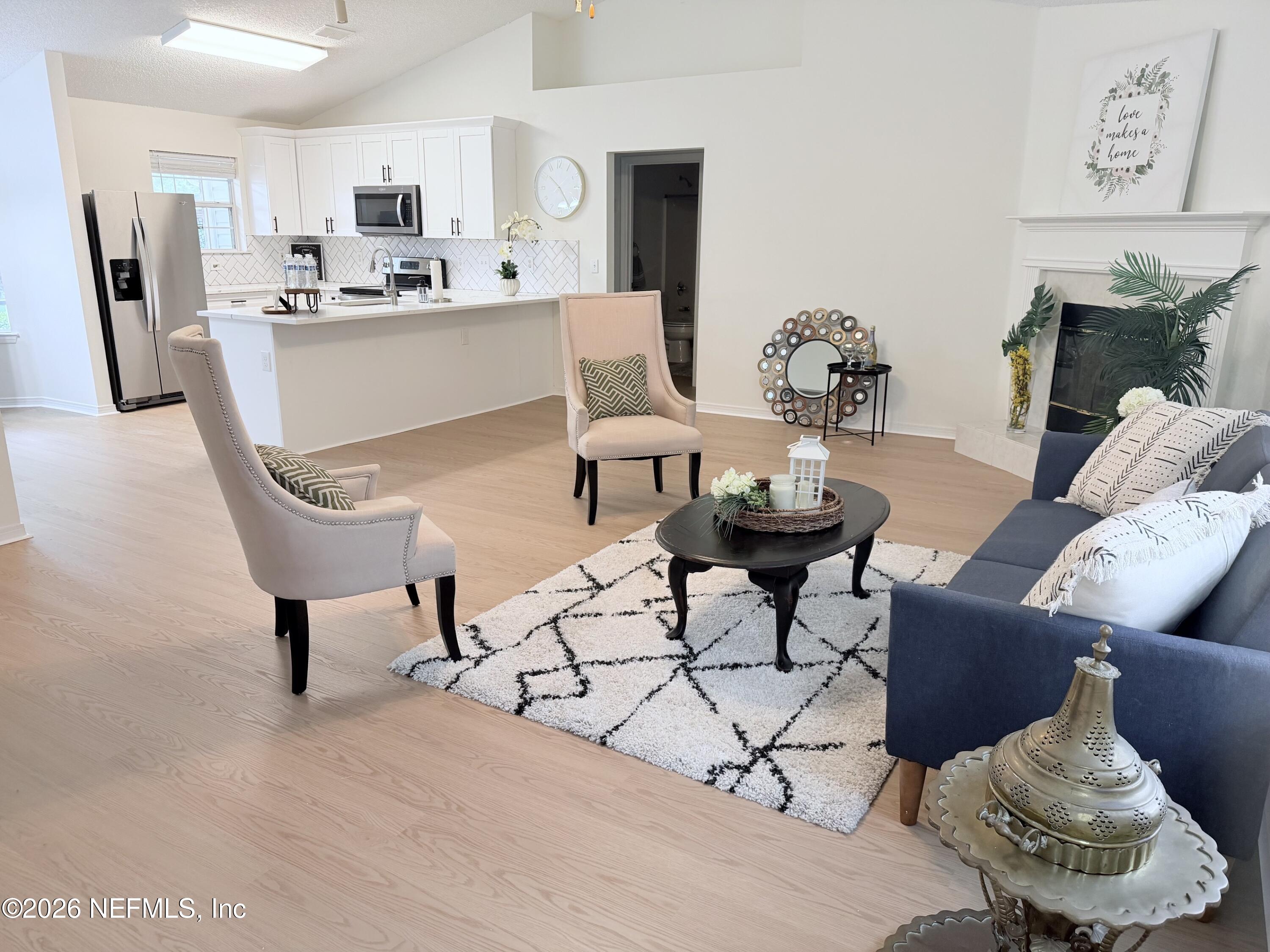 2411 Paris Mill Road Jacksonville, FL 32221 - Photo 12 of 36 a living room with furniture and kitchen view