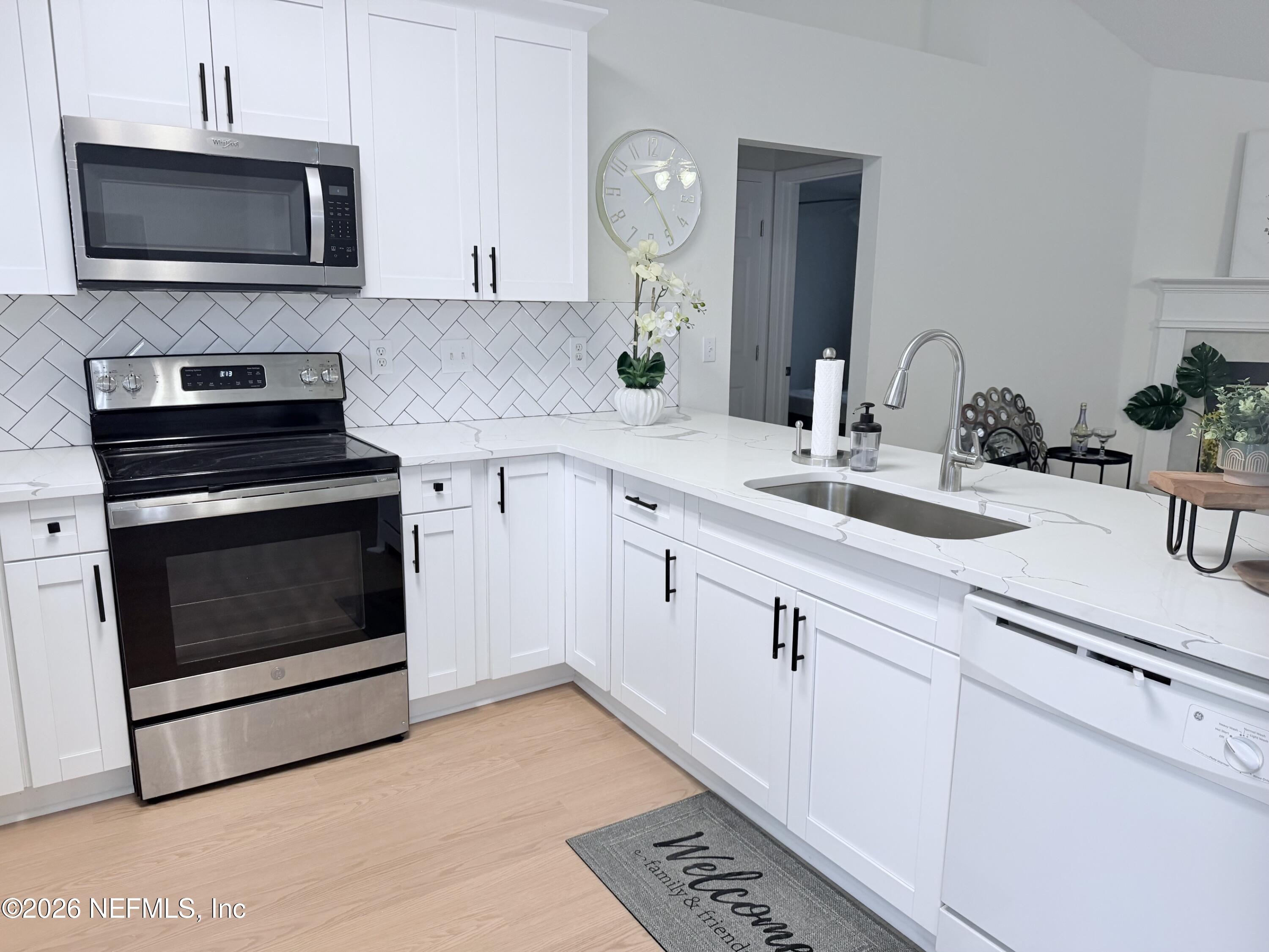 2411 Paris Mill Road Jacksonville, FL 32221 - Photo 18 of 36 a kitchen with cabinets stainless steel appliances and a sink