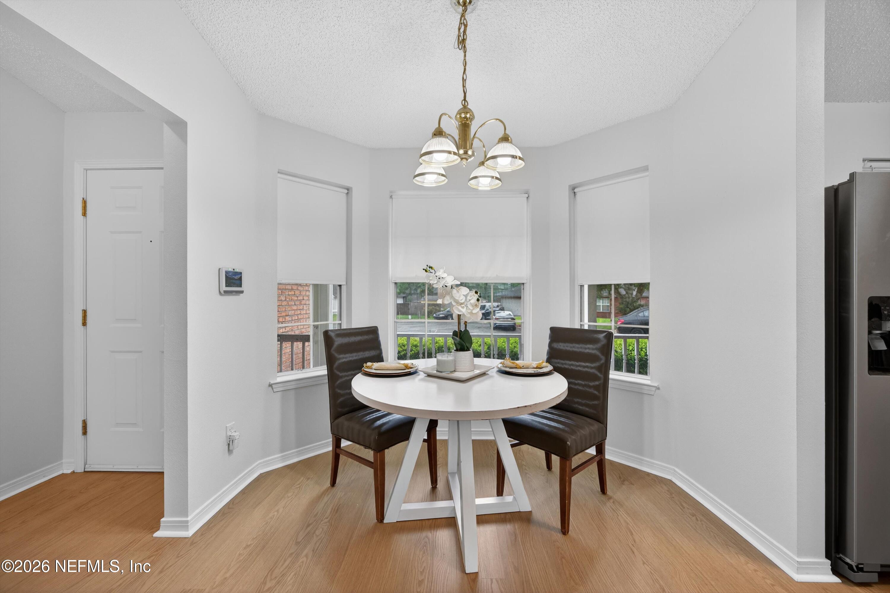 2411 Paris Mill Road Jacksonville, FL 32221 - Photo 20 of 36 a view of a dining room with furniture window and wooden floor