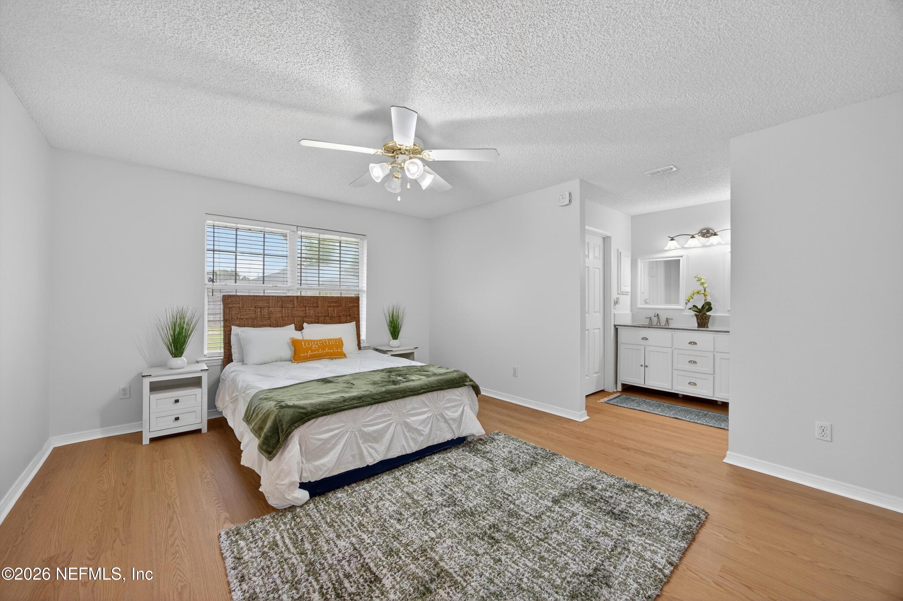 2411 Paris Mill Road Jacksonville, FL 32221 - Photo 23 of 36 a bedroom with a bed lamp and a dresser