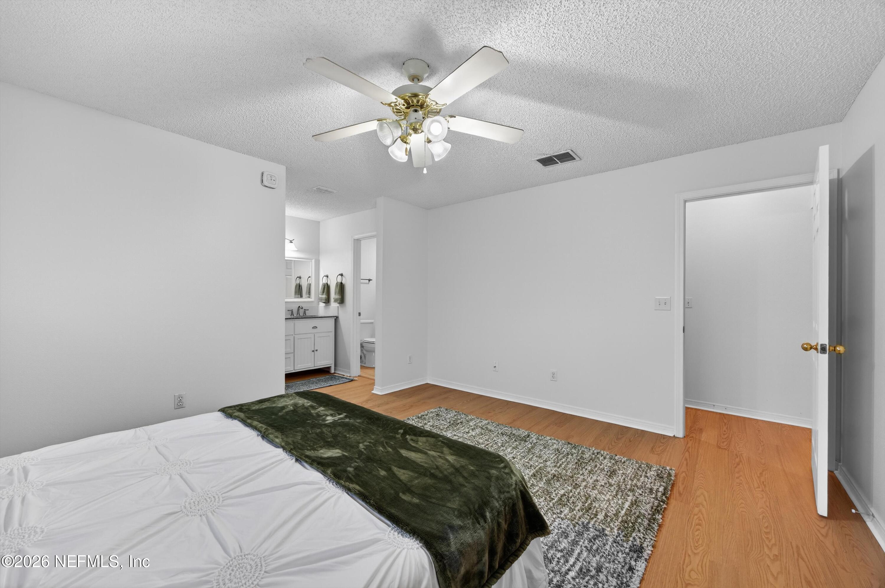 2411 Paris Mill Road Jacksonville, FL 32221 - Photo 25 of 36 a bedroom with a bed and a chandelier