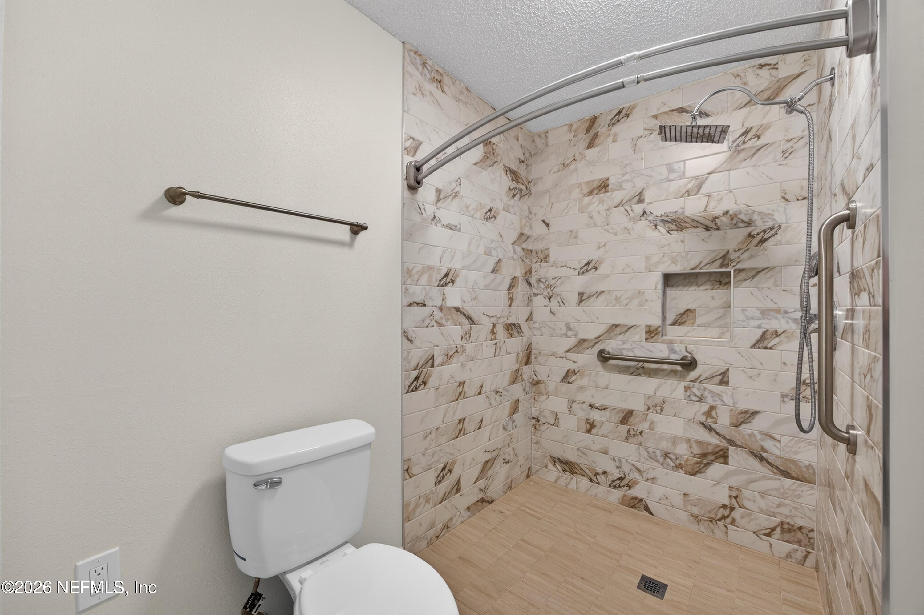 2411 Paris Mill Road Jacksonville, FL 32221 - Photo 28 of 36 a white toilet sitting next to a shower curtain