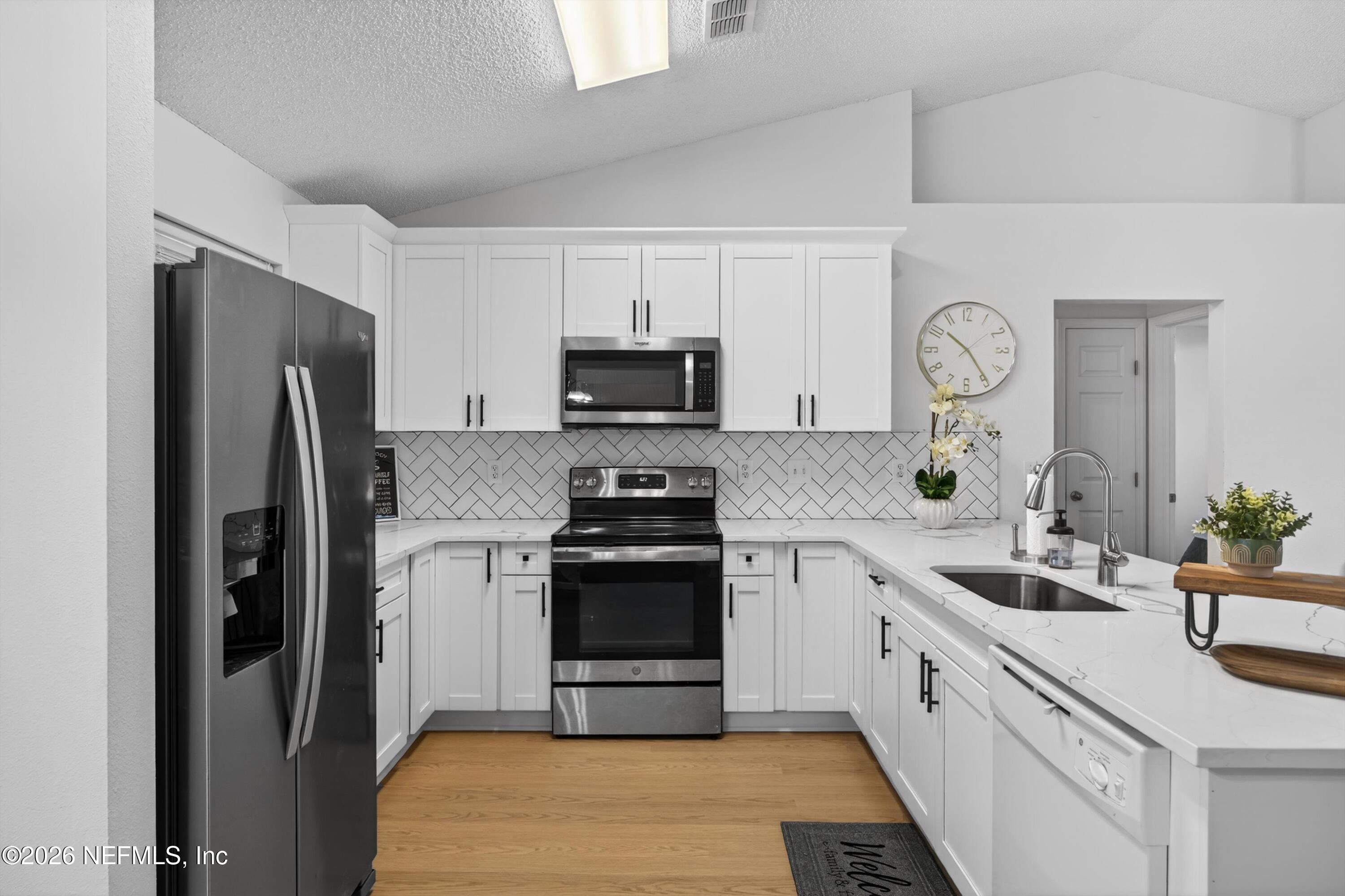 2411 Paris Mill Road Jacksonville, FL 32221 - Photo 3 of 36 a kitchen with a sink stove and refrigerator