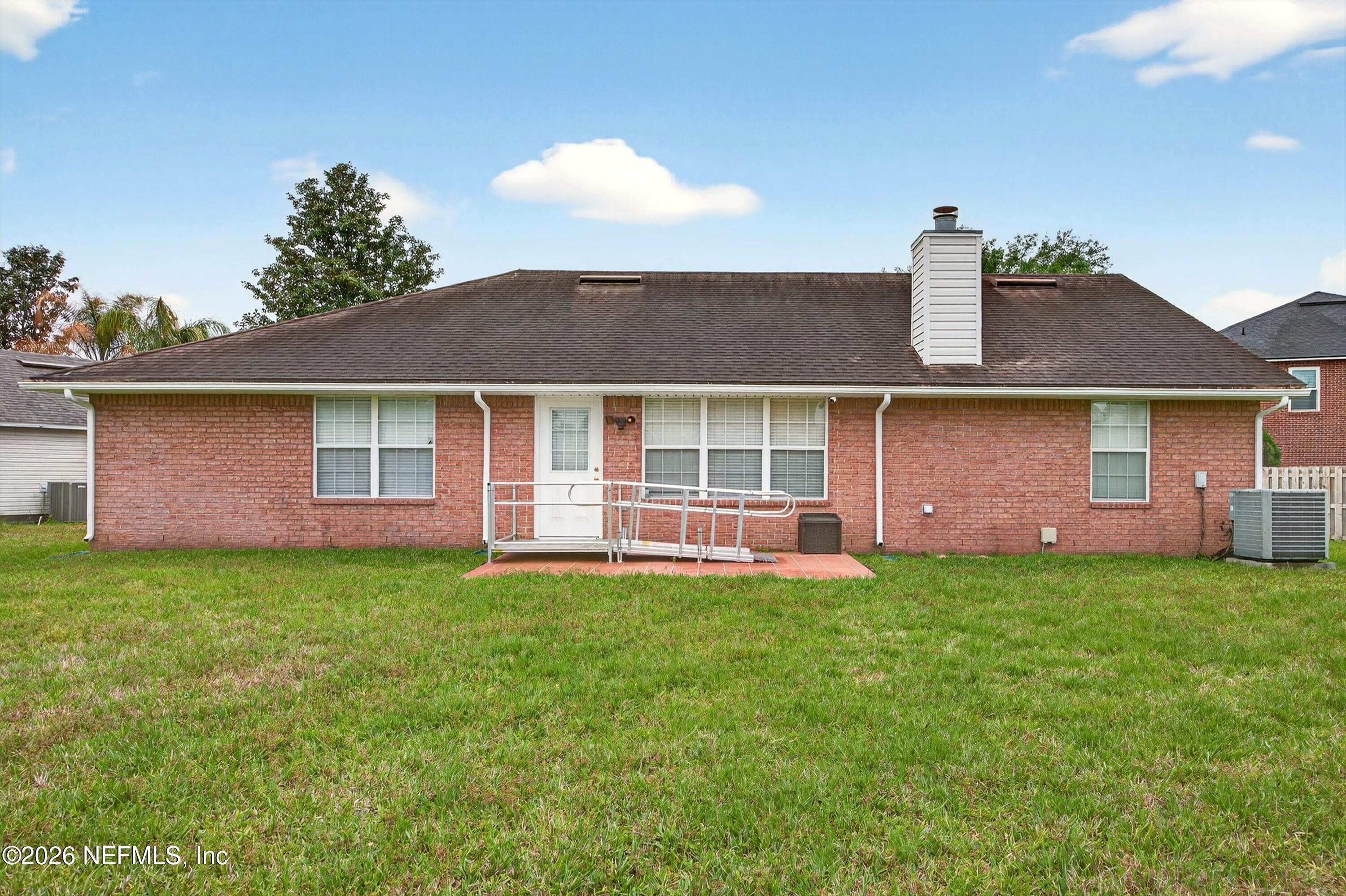 2411 Paris Mill Road Jacksonville, FL 32221 - Photo 31 of 36 a front view of a house with a garden