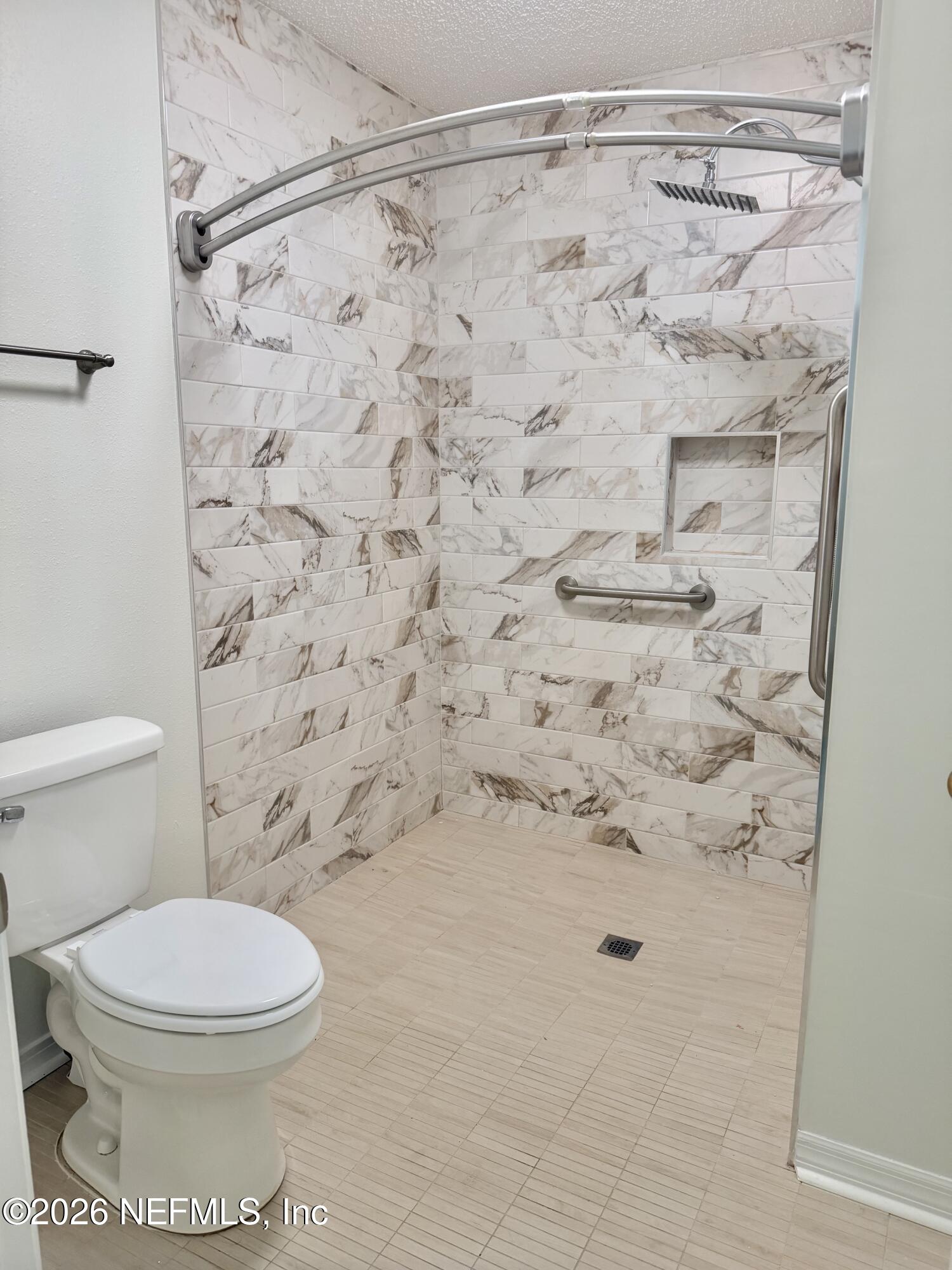 2411 Paris Mill Road Jacksonville, FL 32221 - Photo 6 of 36 a bathroom with a toilet and a shower curtain