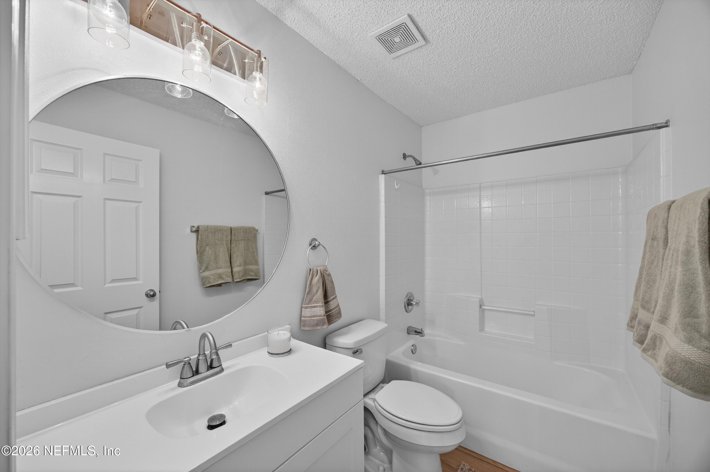 2411 Paris Mill Road Jacksonville, FL 32221 - Photo 9 of 36 a bathroom with a bathtub shower sink vanity mirror and toilet