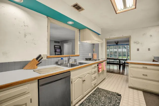 a kitchen with a sink and a stove top oven