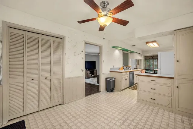 a view of a kitchen with a refrigerator and a stove top oven