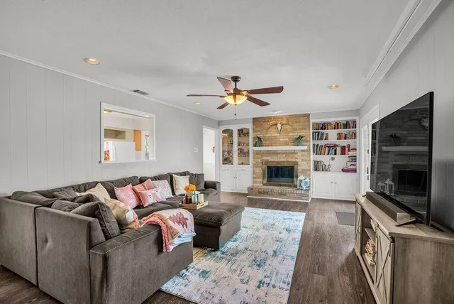 a living room with furniture fireplace and flat screen tv