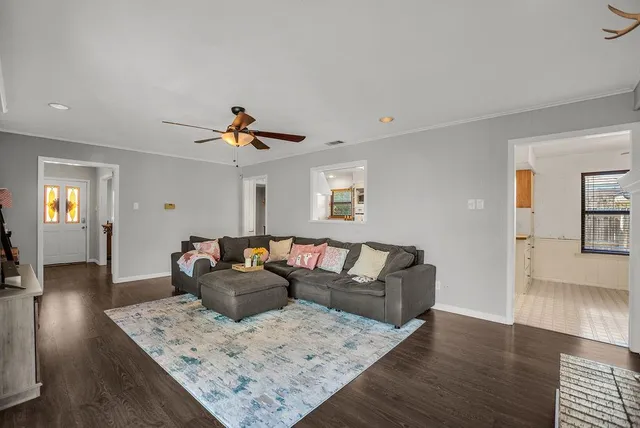 a living room with furniture and wooden floor