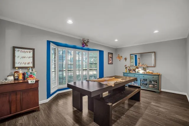 a very nice looking bedroom with a large window and dining table