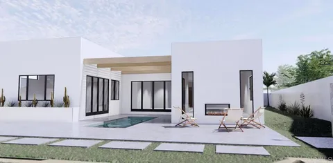 a view of house with yard and sitting area