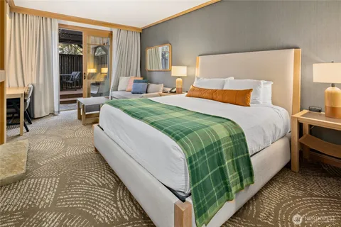 a bedroom with a bed and a couch