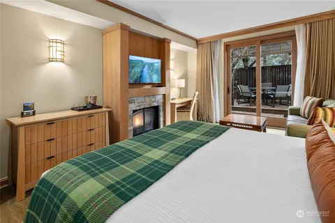 a bedroom with a bed and a dresser next to a window