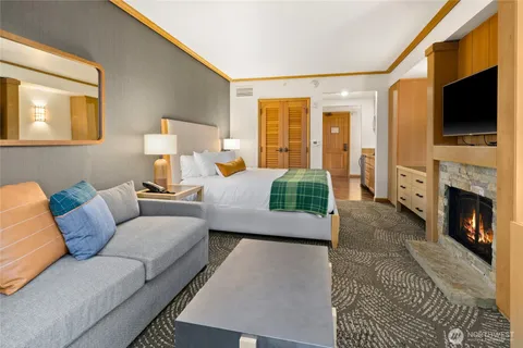 a bedroom with a bed and a flat screen television