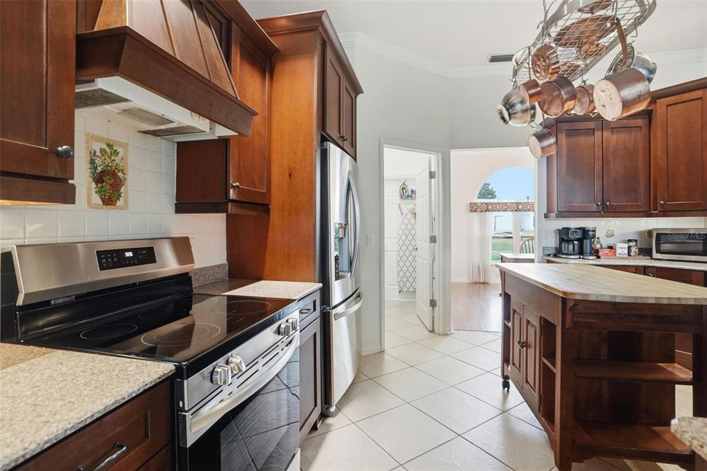 14228 Presteign Lane Spring Hill, FL 34609 - Photo 26 of 89 a kitchen with stainless steel appliances granite countertop a stove and a refrigerator