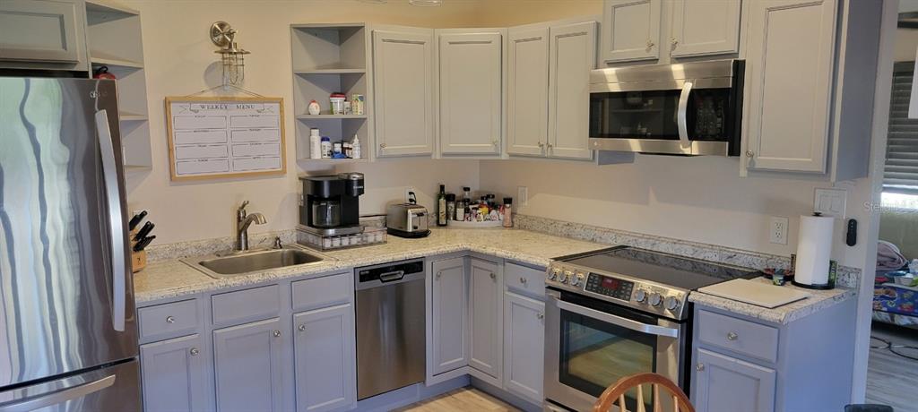 9548 Southwest Falcon Avenue Arcadia, FL 34269 - Photo 12 of 47 a kitchen with a sink stove and microwave