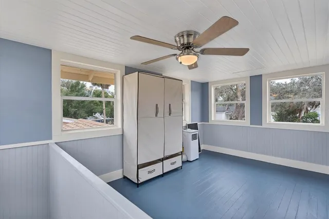 a view of a livingroom with a ceiling fan and window