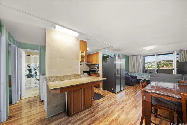 a large kitchen with a table and chairs