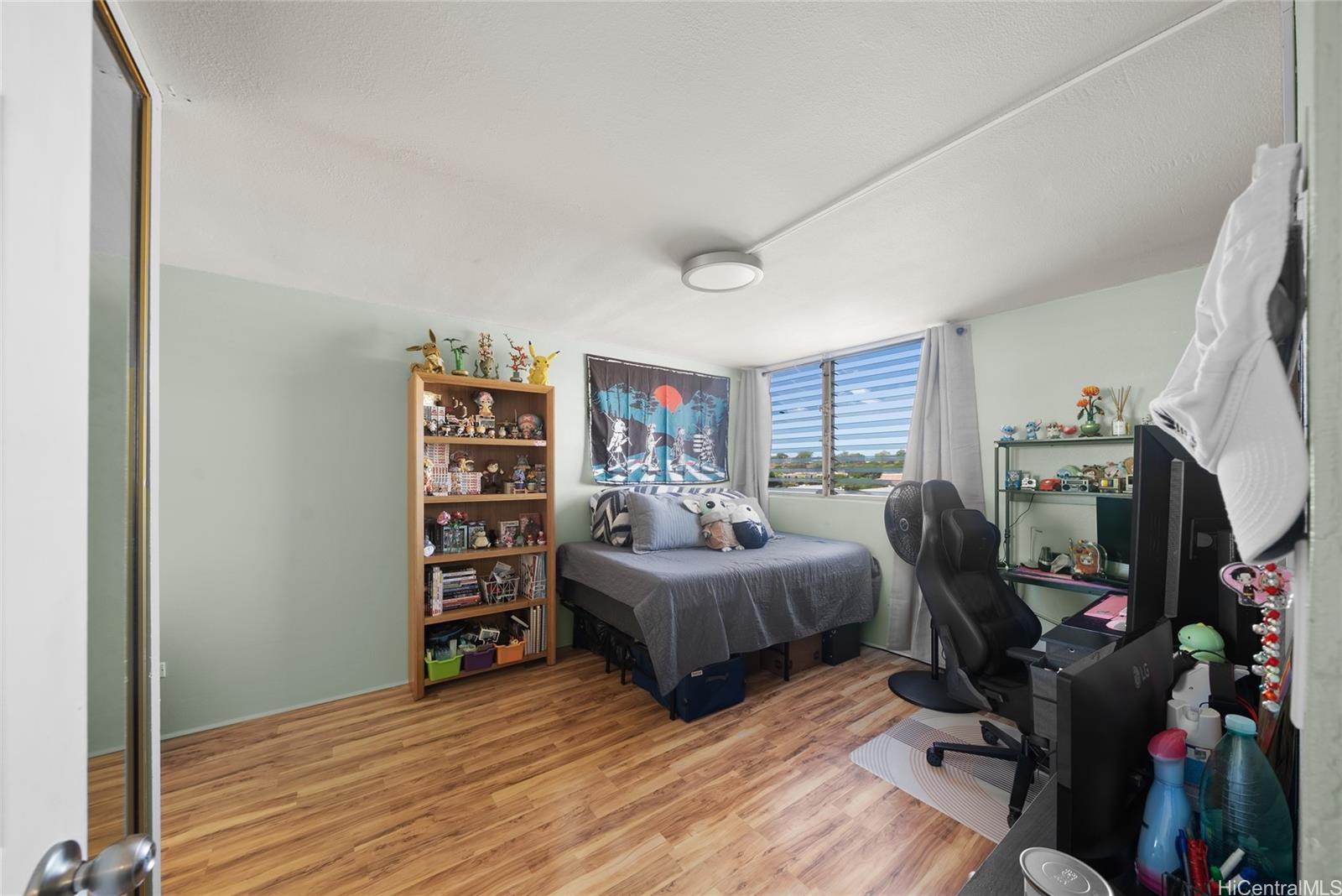 3215 Ala Ilima Street, Unit A510 Honolulu, HI 96818 - Photo 11 of 14 a living room with furniture and a flat screen tv