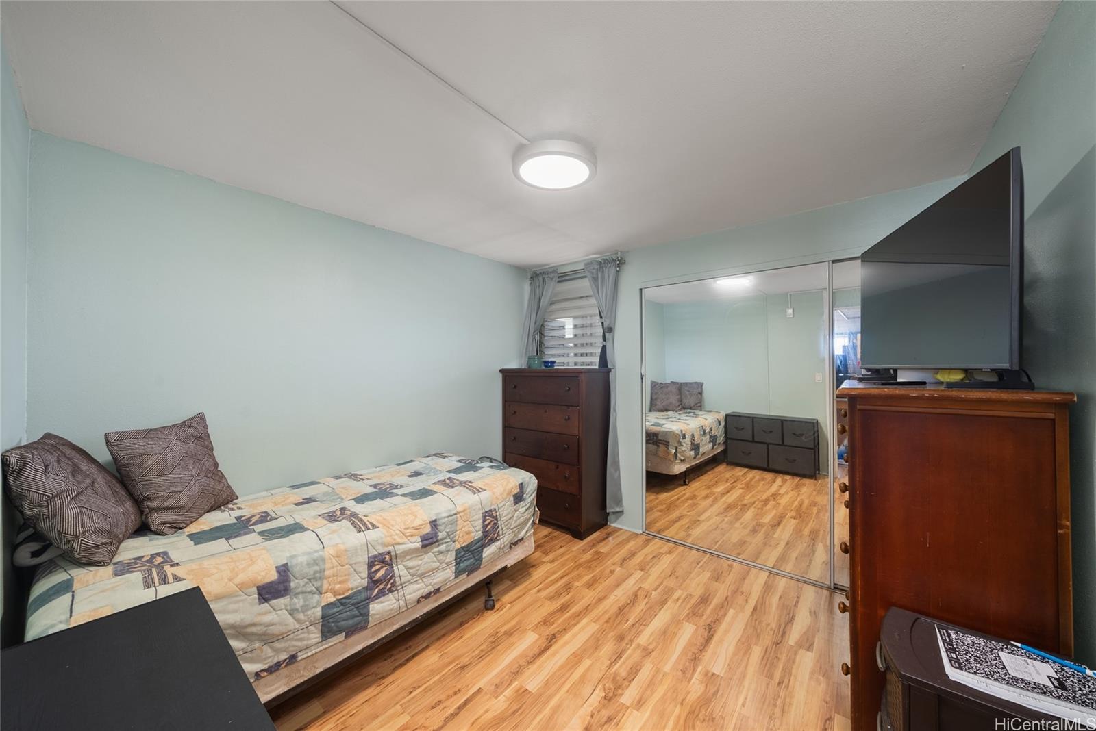 3215 Ala Ilima Street, Unit A510 Honolulu, HI 96818 - Photo 12 of 14 a bedroom with a bed and furniture