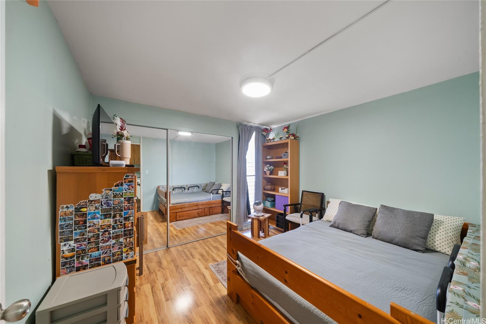 3215 Ala Ilima Street, Unit A510 Honolulu, HI 96818 - Photo 13 of 14 a bed room with furniture and a flat screen tv