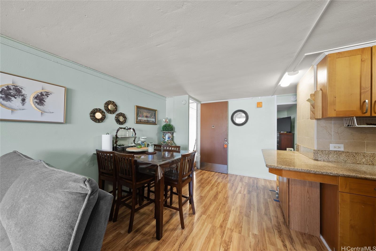 3215 Ala Ilima Street, Unit A510 Honolulu, HI 96818 - Photo 5 of 14 a view of a dining room with furniture and wooden floor
