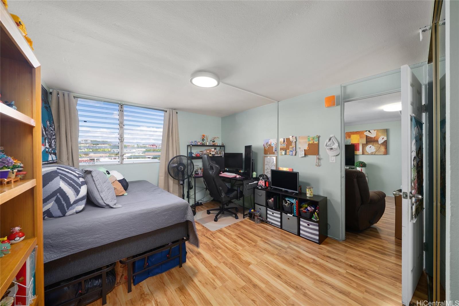 3215 Ala Ilima Street, Unit A510 Honolulu, HI 96818 - Photo 6 of 14 a living room with furniture and a flat screen tv