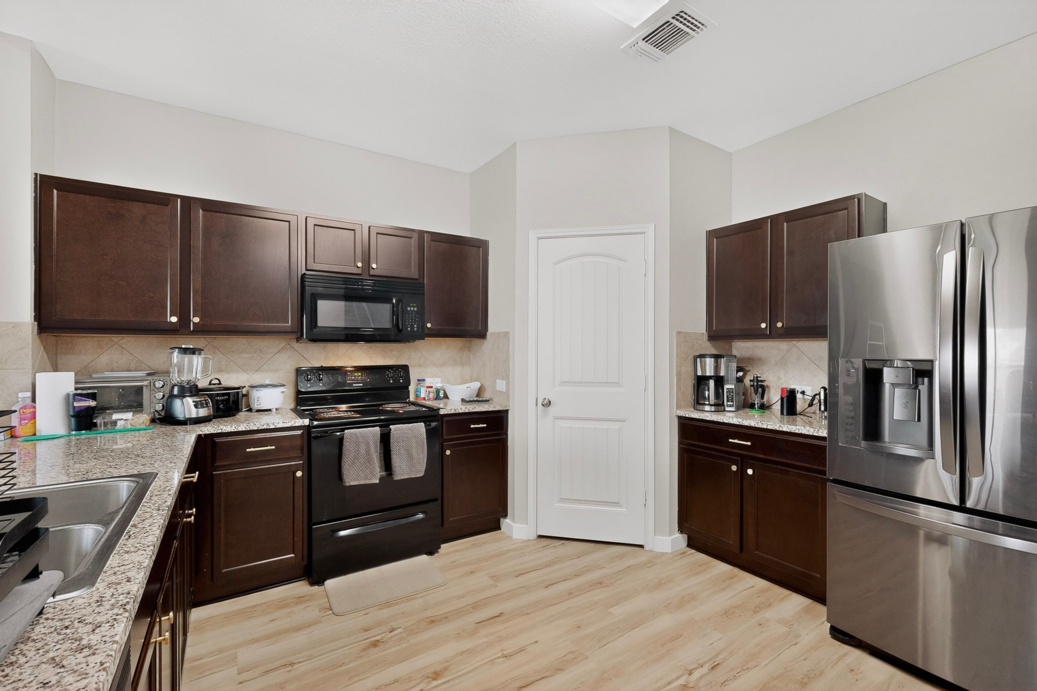 14513 Esker Road Manor, TX 78653 - Photo 11 of 38 A well-appointed kitchen features rich cabinetry, appliances.