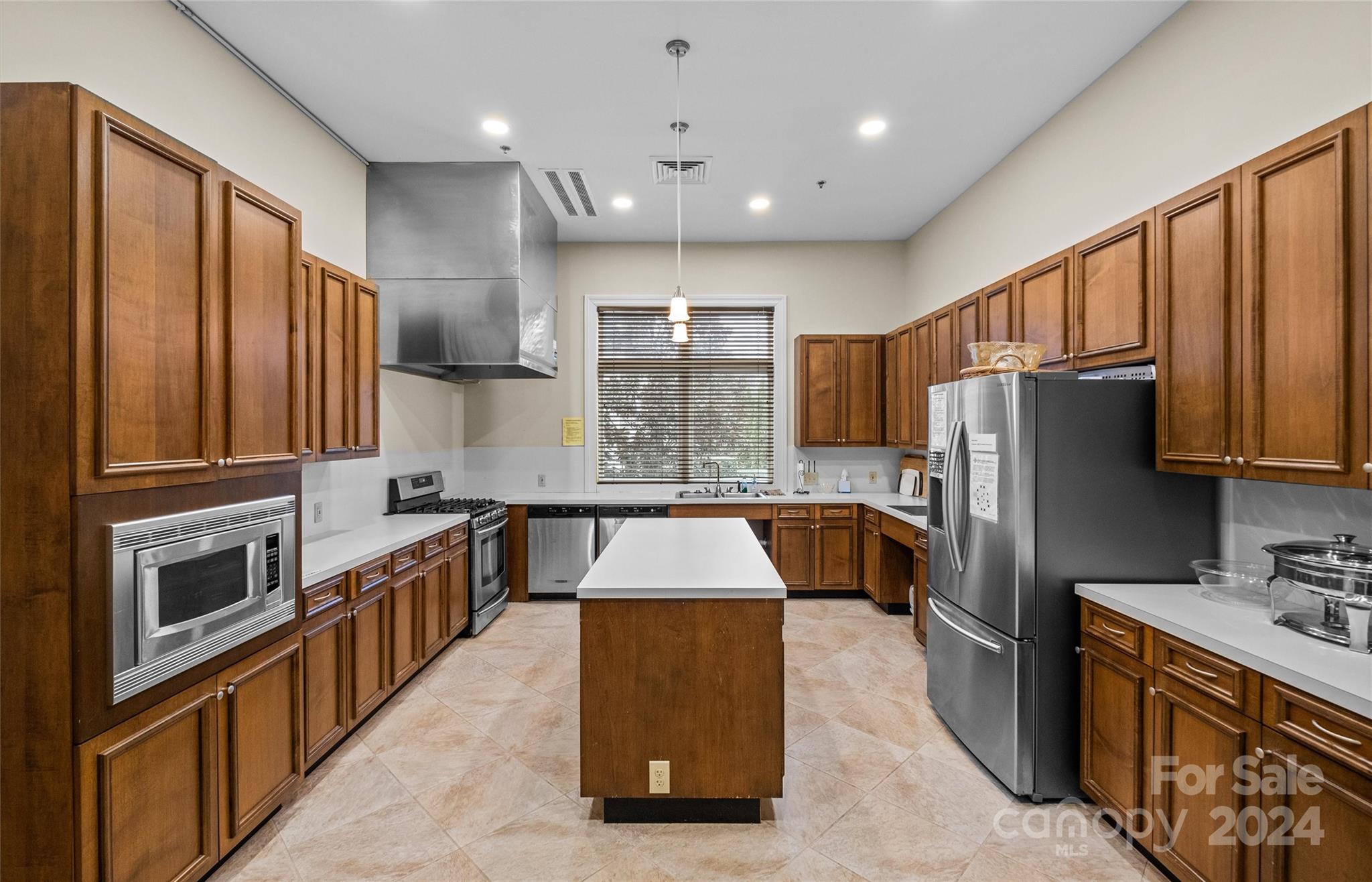 978 Platinum Drive Fort Mill, SC 29708 - Photo 43 of 48 a kitchen with stainless steel appliances granite countertop a refrigerator a stove a sink dishwasher and wooden cabinets with wooden floor