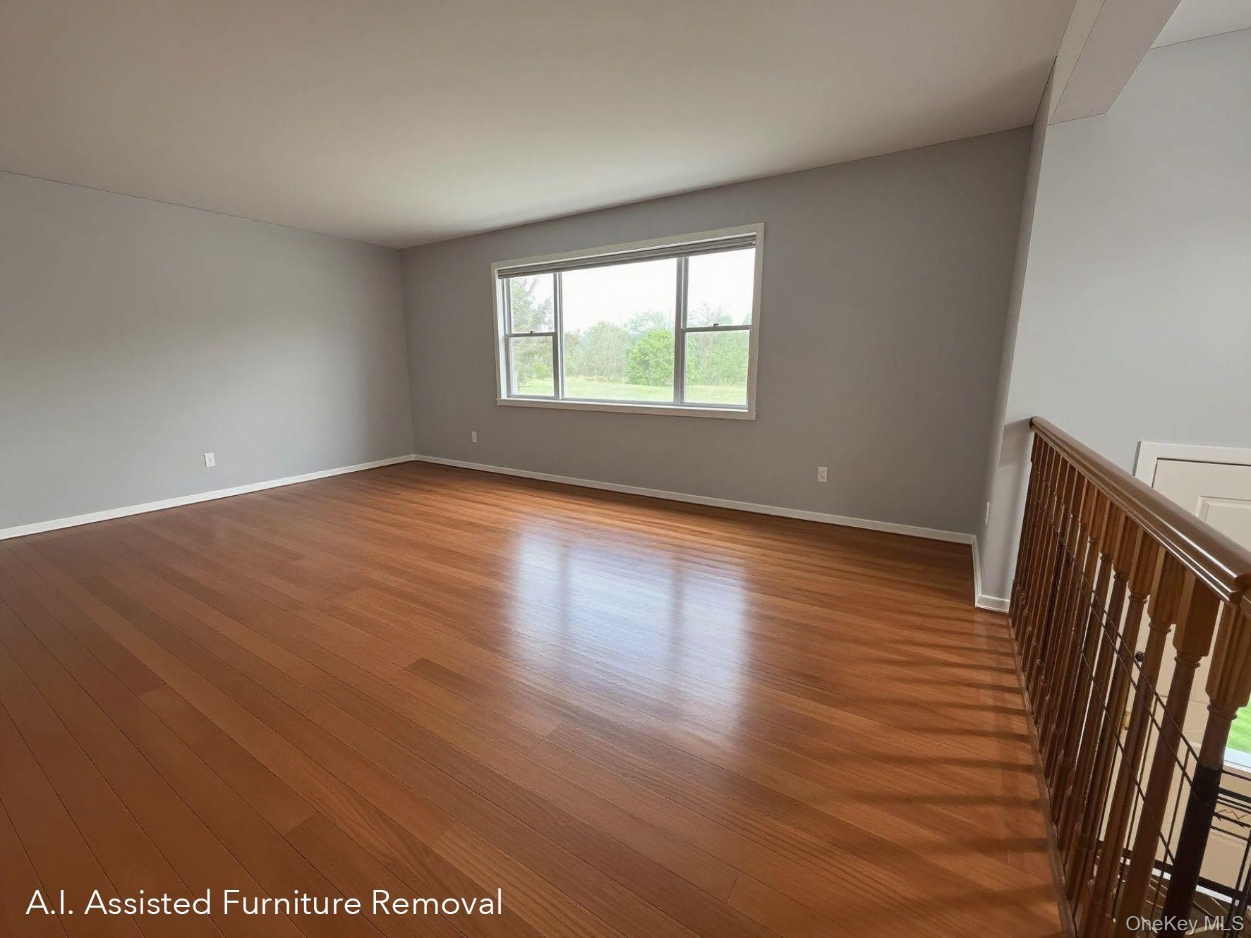 94 Booth Road Chester, NY 10918 - Photo 4 of 21 Primary living room is a well lit (south west exposure) and spacious, featuring wood floors, light gray wall paint, and white baseboards