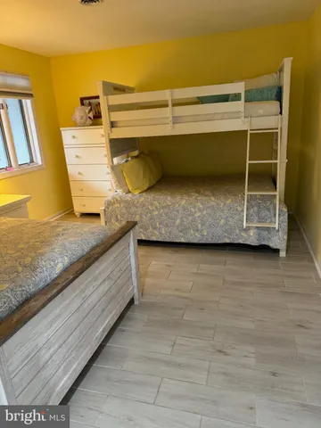 a bed sitting in a bedroom next to a tv