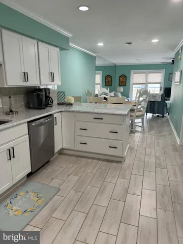 a kitchen with granite countertop a stove top oven microwave and cabinets