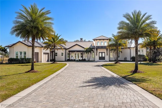 a view of a house with swimming pool and a small yard