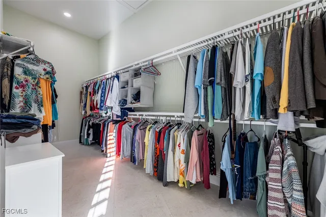 a view of walk in closet with clothes