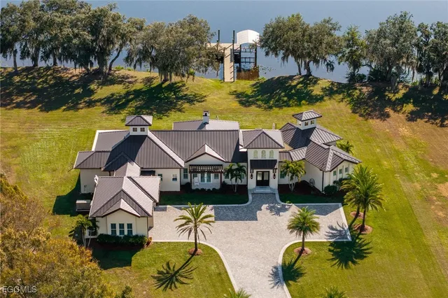 a aerial view of a house with a swimming pool and outdoor seating