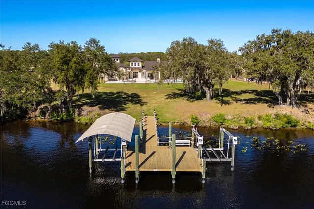 a view of a lake with lawn chairs