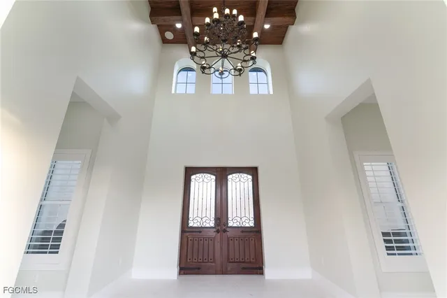 a hallway with windows and chandelier