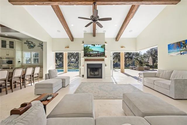 a living room with furniture a fireplace and a chandelier