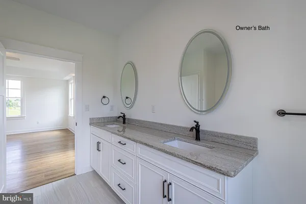 a bathroom with a granite countertop sink a mirror and vanity