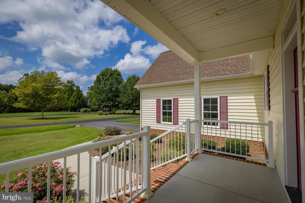 a view of a house with backyard and porch