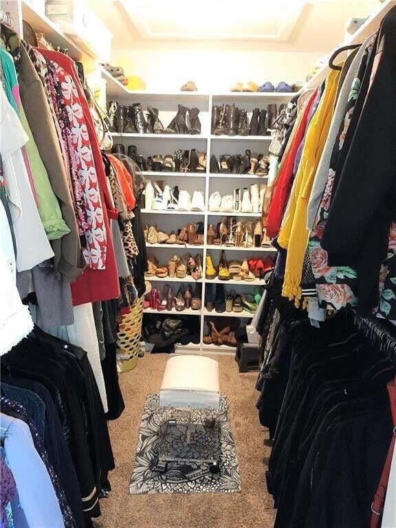 1679 Northwest 15th Vista Boca Raton, FL 33432 - Photo 11 of 15 a view of walk in closet with clothes and shoes