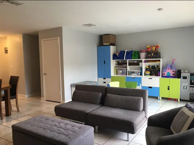 a living room with furniture and a wooden floor